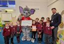 Proud – pupils at Prettygate Primary School with St Helena Hospice mascot, Saunders, and headteacher, Mark Millbourne