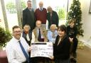 Manager of the Officers' Club John Scarff and members present a cheque for £1,000