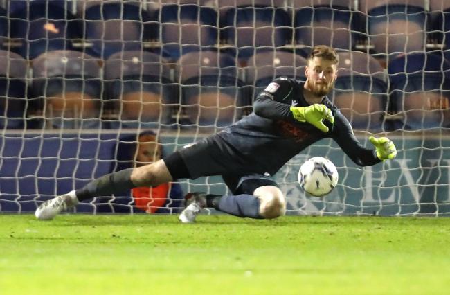 Eye on the ball - Colchester United goalkeeper Jake Turner makes a save against Newport County Picture: STEVE BRADING