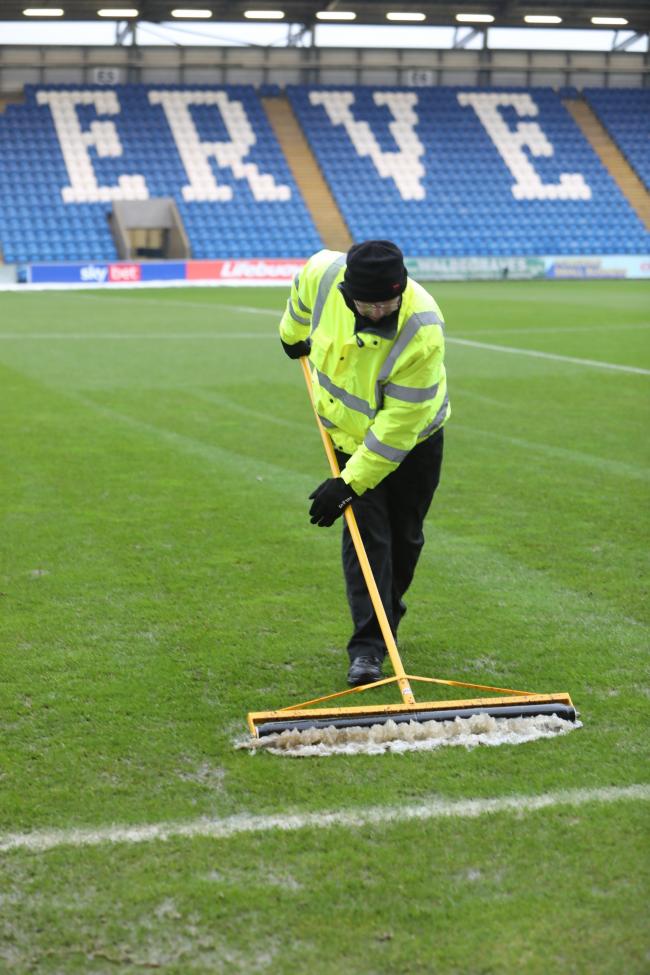 Water, water, everywhere - Colchester United staff attempt to clear the JobServe Community Stadium pitch of water prior to their postponed game against Rochdale Picture: STEVE BRADING