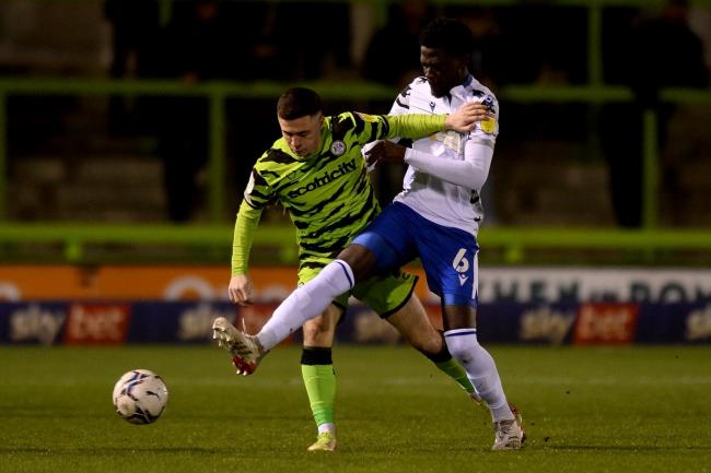 Tussle - Colchester United's Brendan Wiredu does battle with Jack Aitchison of Forest Green Rovers during the clash at the Fully Charged New Lawn Picture: RICHARD BLAXALL