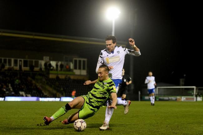 Tussle - Colchester United's Charlie Daniels does battle with Kane Wilson of Forest Green Rovers during the League Two clash at the Fully Charged New Lawn Picture: RICHARD BLAXALL