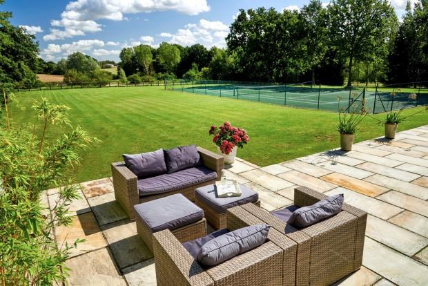 Gazette: Spacious - outside you will find plenty of garden space, alongside a tennis court and seating area