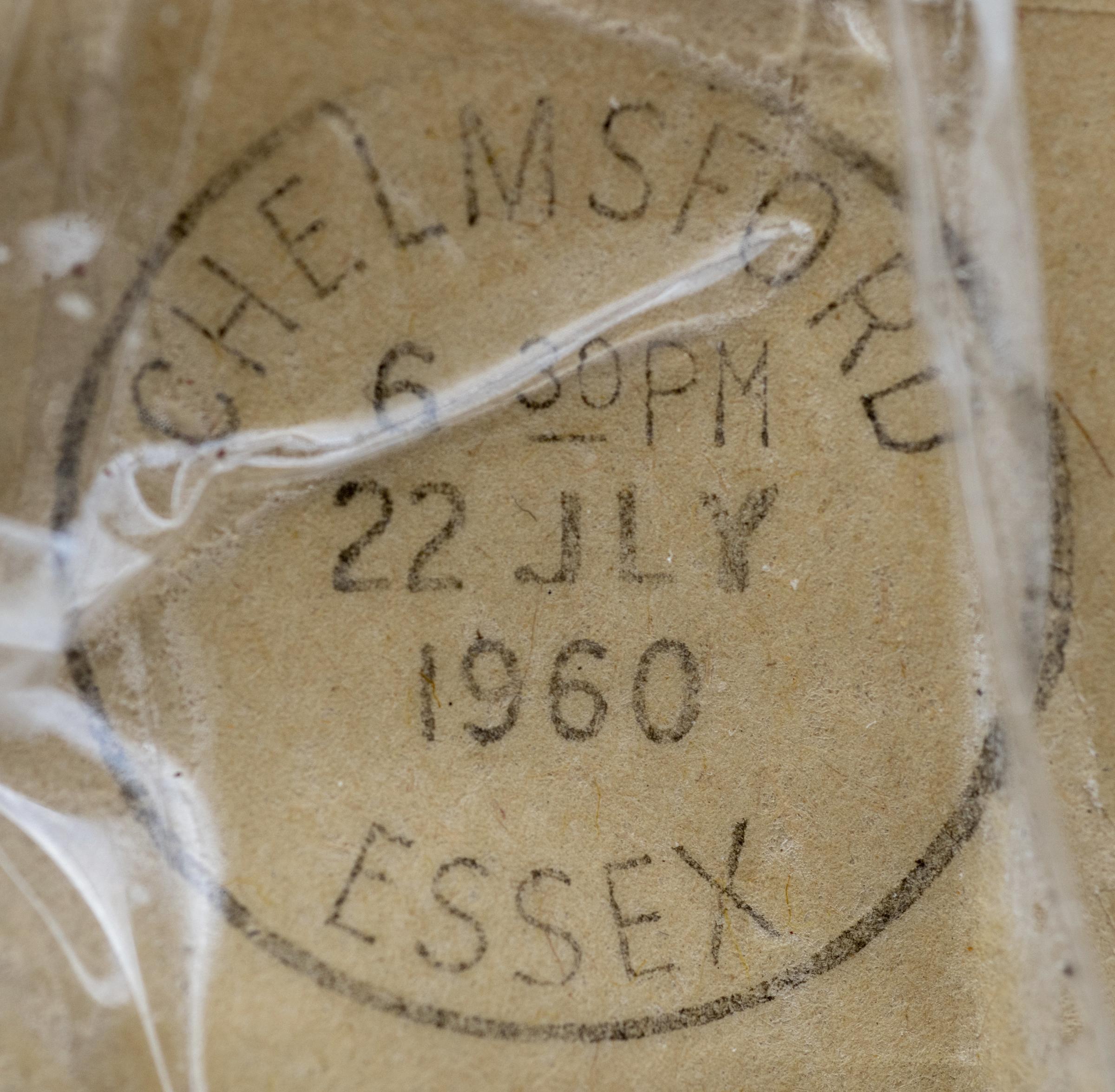 The package has a postmark from Chelmsford, Essex dated 6:30pm 22 July 1960 and two one-and-a-half old pence stamps. 