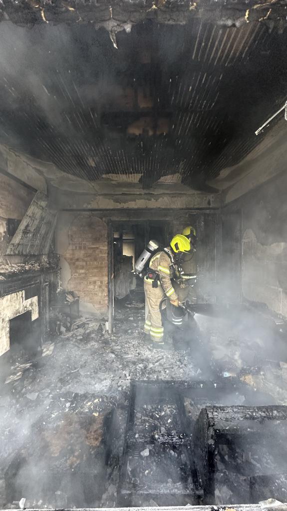 Gazette: A firefighters tackling the fire in Turner Road Gazette: A firefighters tackling the fire in Turner Road