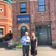 Donation – Hayley Songhurst, a Senior Associate Solicitor with Ellisons, presents the £1,000 “Twinkle Star” statue cheque to Sir Bob Russell.