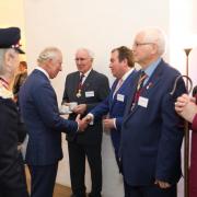 Moment - King Charles speaks with Colchester councillor Darius G Laws and then Colchester High Steward Sir Bob Russell