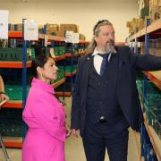 Vital - Michael Beckett shows Priti Patel the range of food stock held at the Colchester Foodbank