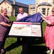 Unveiling – Rosemary Jewers, Councillor Dave Harris, and Councillor Michelle Burrows present the new explainer