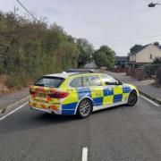 Emergency - a police car blocks London Road in Kelvedon the morning after the crash