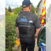 Warrant - a police officer at the scene of the raid in Holman Close