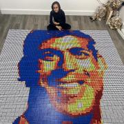 Triumph - Henil Soni with his Rubik's cube version of Prime Minister Sunak measuring 42 by 42 or 1764 Rubik's cubes