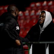 Familiar face - former Colchester United favourite and current Stoke City defender Junior Tchamadeu chats with his ex-team-mate John Akinde after the game at Salford City