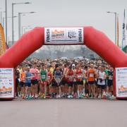Runners lined up on the start line at the JobServe Community Stadium.