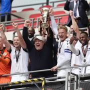 Trophy time - Bromley boss Andy Woodman celebrates with the play-off trophy following their penalty shoot-out win over Solihull Moors