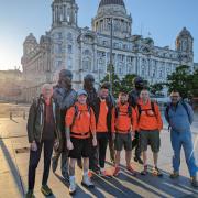 Challenge - Jake Quickenden (centre) and Chris Metcalfe (third right) at the start of their walk in Liverpool