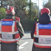 A pair of security guards working under Operation Vanguard, passing through the Sainsbury's car park, patrolling in Braintree town centre, 27 October 2026.
