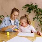 A teacher and student with SEND engage in creative finger painting at a table indoors. (Image: Pexels,  Antoni Shkraba)