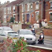 Waiting game - armed police in Old Heath Road. Picture: JAMES TUTE