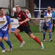 Jamie Shaw (in stripes) scored Coggeshall's second goal at Wroxham
