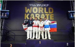 Big achievement - England's Lewis Doyland (second right) after claiming the world title at the WUKF Karate World Championships, in Dundee