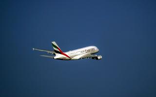 An Emirates flight has landed at Manchester Airport and emergency crews have surrounded it as a suspected 
