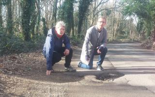 Frustrated - councillors Fay Smalls and Lee Scordis pictured with a large pothole in Weir Lane