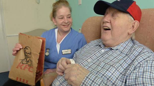 Gazette: Ron Stone, resident at The Corner House care home in Clacton with care worker Lynda Green who took Ron the KFC to see the workings behind the scenes.